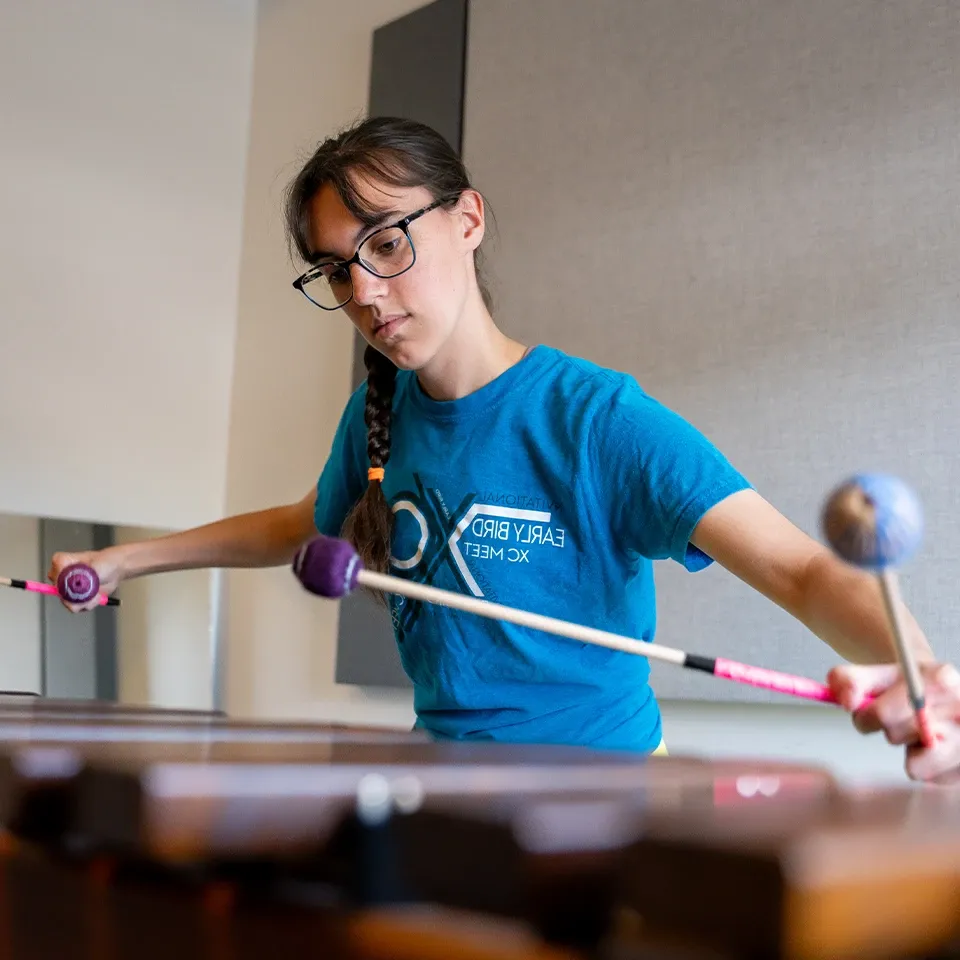 Music student practicing on a xylophone